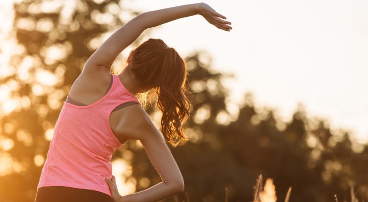 a woman stretching in work out clothes