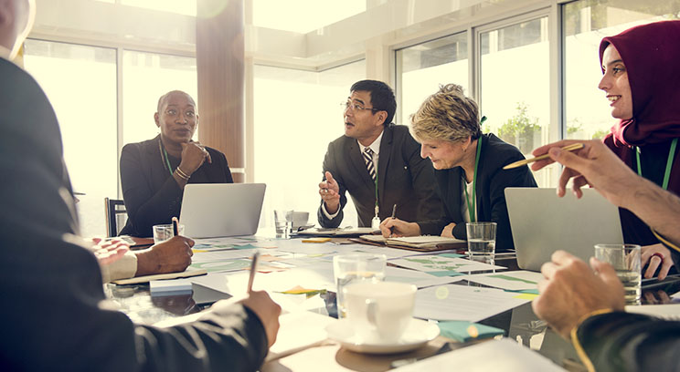a diverse group of business people discussing around a table