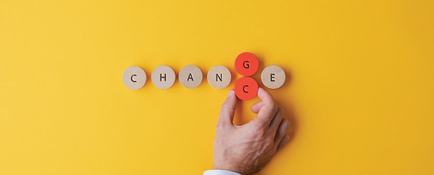 Wooden blocks with letters that could read change or chance.