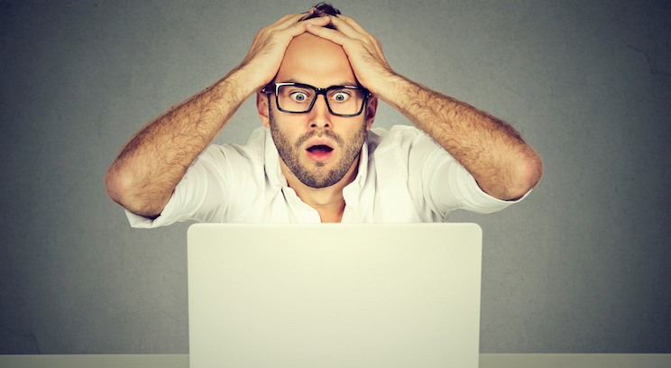 stressed man at laptop