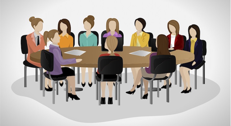 a group of business women at a conference table