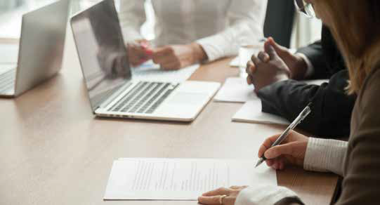 person writing in a meeting