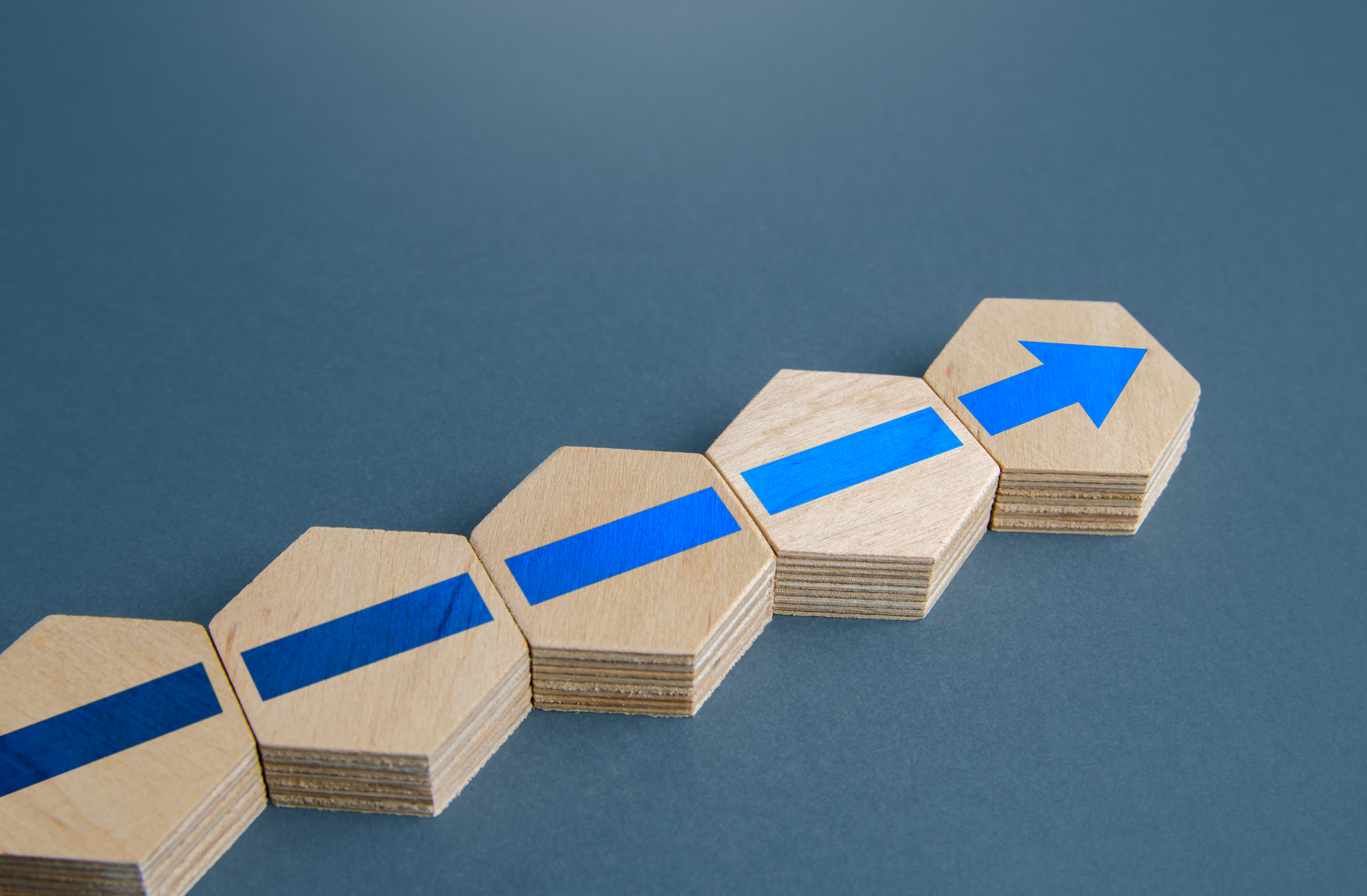 An additional block with an blue arrow signifying a continuation of progress.