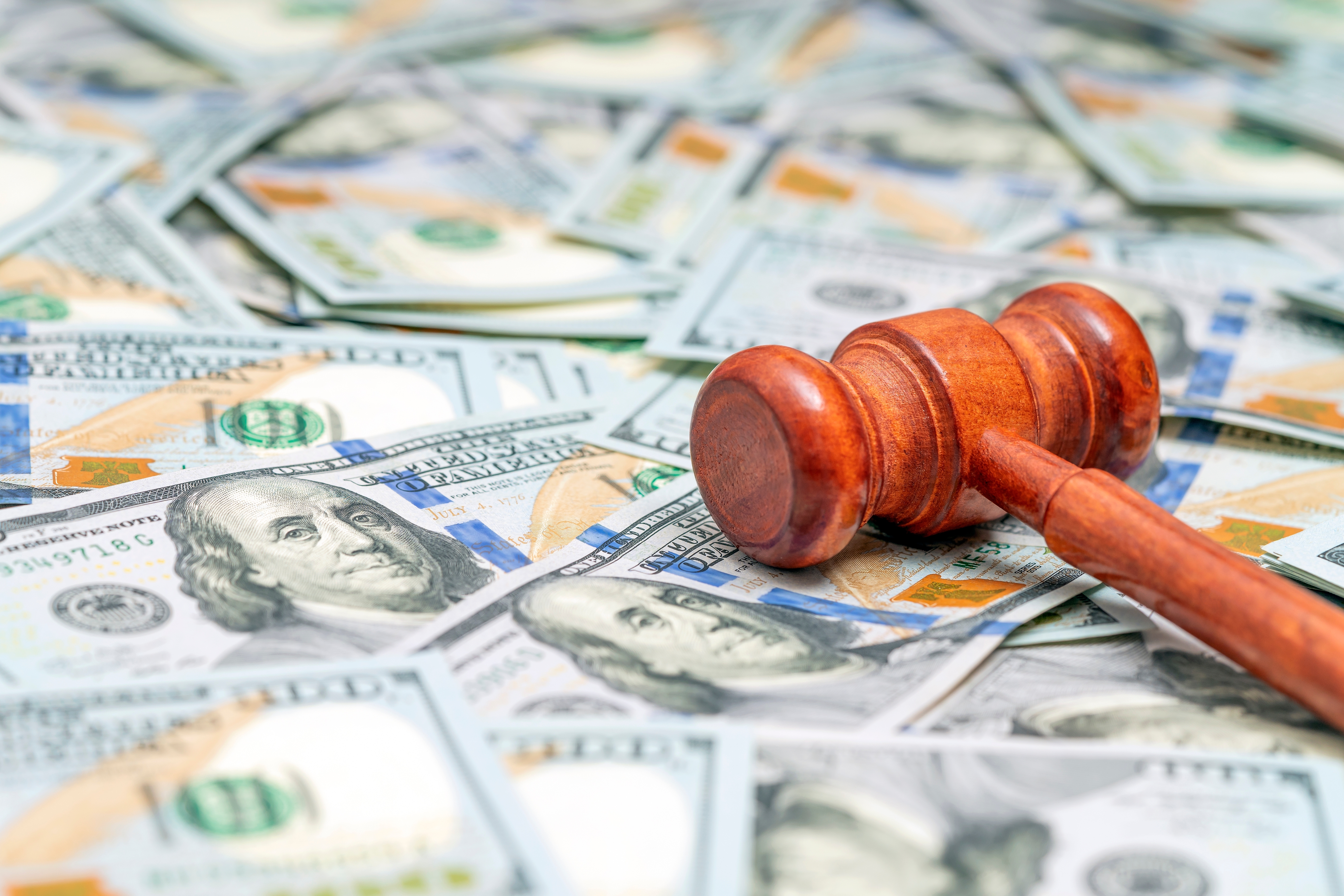 Judge hammer on American money background.