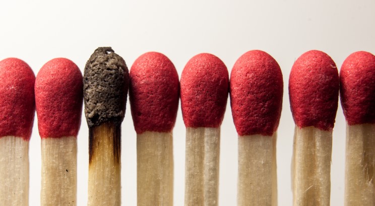 a row of matches. one is burnt out