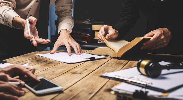 several documents being discussed around a table