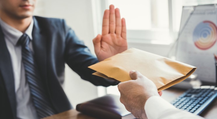a man in a suit rejecting a package