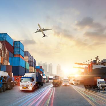 International trade represented by an airplane, cargo ship, trucks, and freight containers