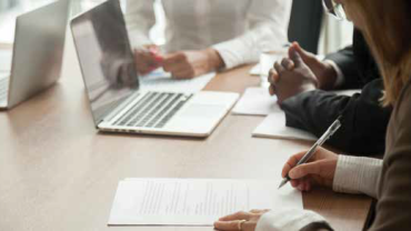 person writing in a meeting