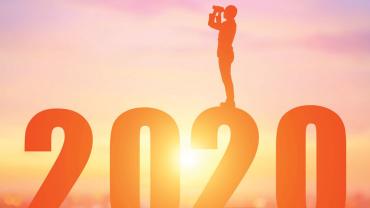 Figure standing on top of 2020 and looking back with binoculars
