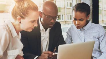 Business people looking at a laptop