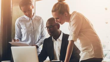 Business people looking at a laptop