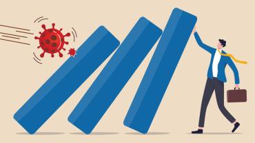 businessman holding up a barrier between him and a virus