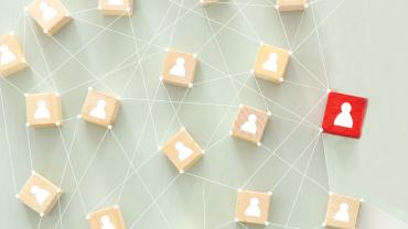 Multiple wooden blocks connected to each other. one is red.