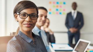 a woman in professional attire smiling at the camera