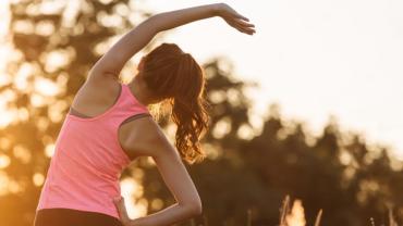 a woman stretching in work out clothes