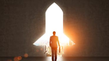 a doorway in the shape of a rocket ship frames a man walking out into the city holding a briefcase