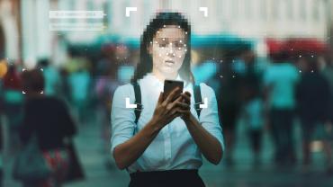 Women on phone, face pixelated