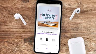 Smart phone with earbuds on a wood table