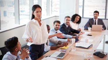 Business woman addressing boardroom
