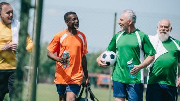 Older men finishing soccer game