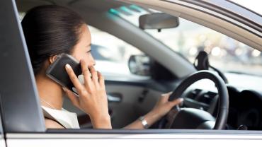 Woman taking a work call from her car