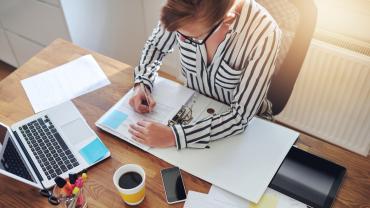 Woman writing in binder