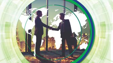 Two men, one Asian, in suits, shaking hands