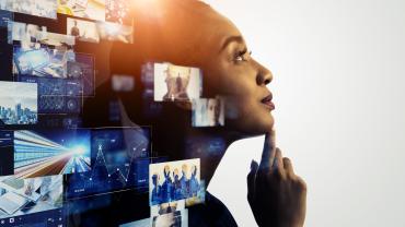 black-skinned, woman -- looks like -- against monitor with computer images on it and coming out around her