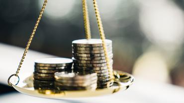 coins balancing on a scale