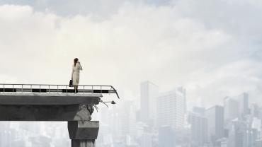 business woman standing on a destroyed bridge