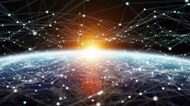 sun peaking over earth from space