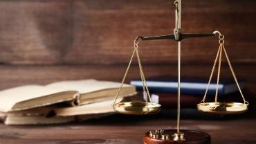 Legal scales next to legal books on a table. 