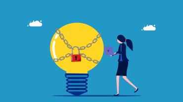 Lawyer holding a computer standing next to a light bulb "idea" with a padlock on it. 