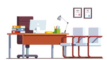 Lawyer's office with a table, books, and legal degrees. 