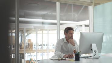 Businessman focuses intently on computer