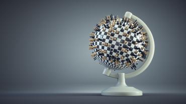 globe with chess pieces sticking menacing out from it