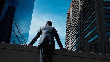 Business leader between buildings