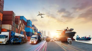 International trade represented by an airplane, cargo ship, trucks, and freight containers