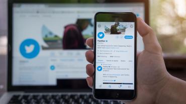 the Twitter application open on a phone and a computer