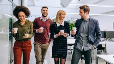 4 business people walking and talking