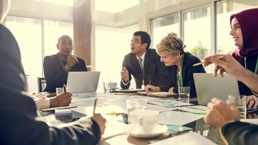 a diverse group of business people discussing around a table