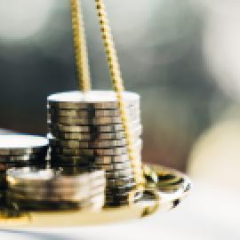 coins balancing on a scale