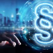 Hand reaching out to blue glowing section sign in front of a blue city skyline.