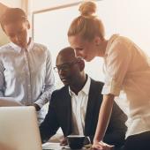 Business people looking at a laptop
