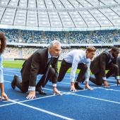 people in business attire at a track starting line