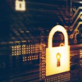 yellow/gold padlock in front of computer technology