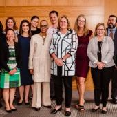 a group of 14 professionals pose as a group during the event
