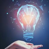 hand holding a lightbulb