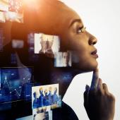 black-skinned, woman -- looks like -- against monitor with computer images on it and coming out around her